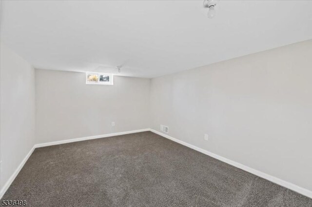 basement with dark carpet