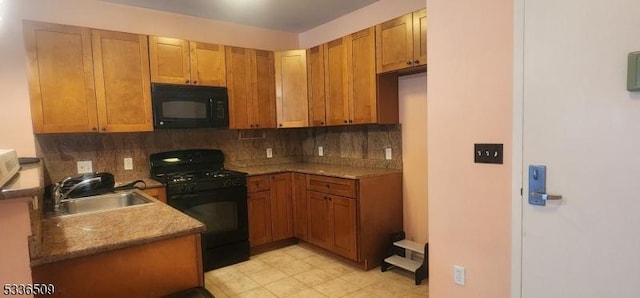 kitchen with tasteful backsplash, sink, and black appliances