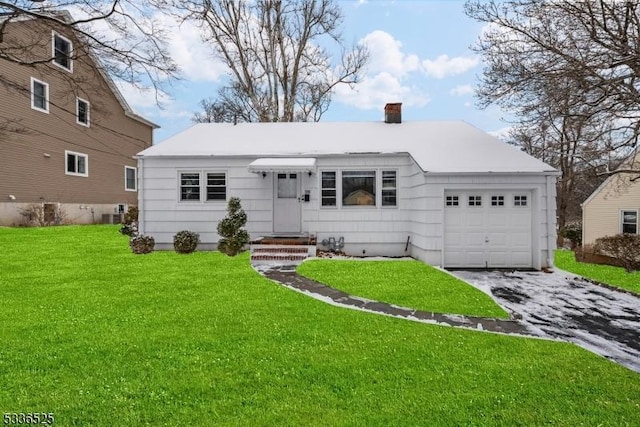 ranch-style home with a garage and a front yard