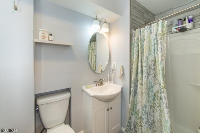 bathroom with vanity, toilet, and a shower with shower curtain