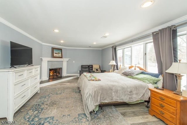 bedroom featuring multiple windows, ornamental molding, and light hardwood / wood-style floors