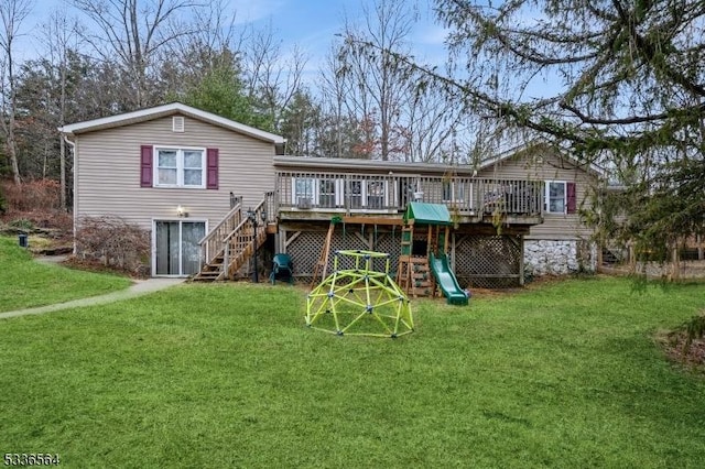 rear view of house featuring a playground, a deck, and a lawn