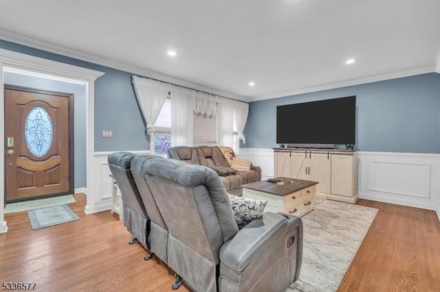 living room with crown molding and light hardwood / wood-style flooring