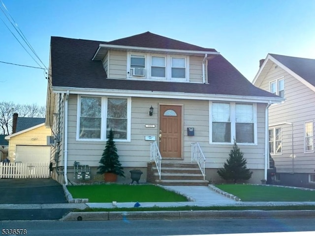 view of front of house with cooling unit, a garage, and an outdoor structure