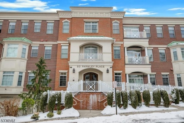 view of property with french doors and brick siding