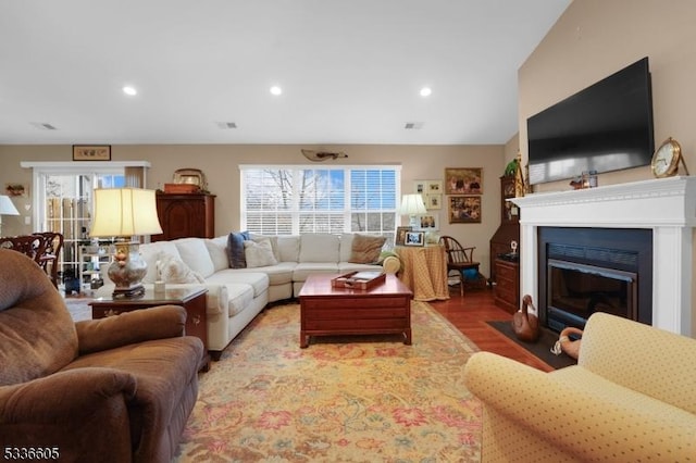 living room with hardwood / wood-style flooring and vaulted ceiling