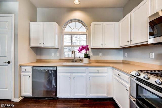 kitchen featuring white cabinetry, sink, and appliances with stainless steel finishes