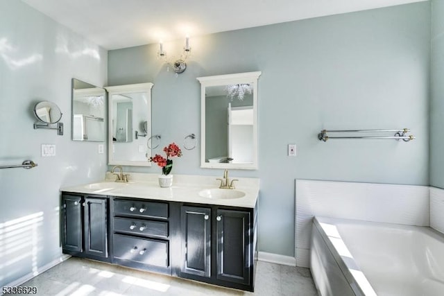 bathroom featuring vanity and a washtub