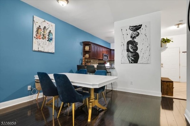 dining space featuring dark hardwood / wood-style floors