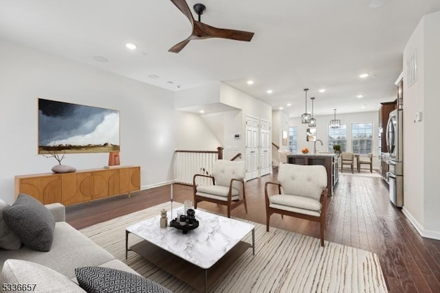 living room featuring hardwood / wood-style flooring and ceiling fan