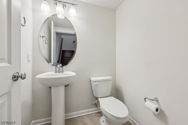 bathroom with tile patterned flooring, sink, and toilet