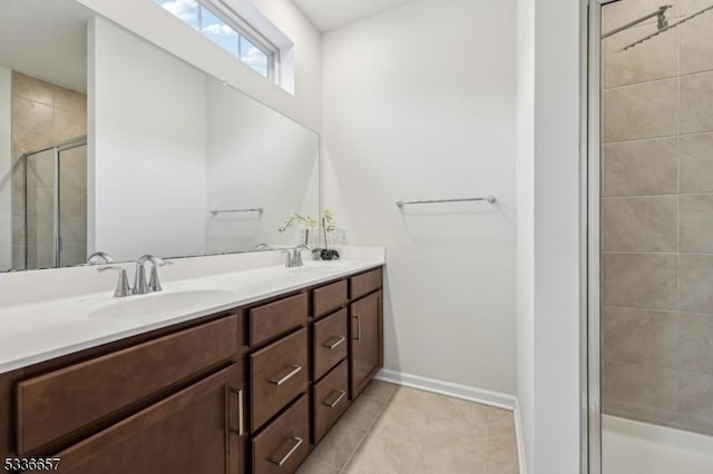 bathroom featuring tile patterned floors, vanity, and a shower with shower door