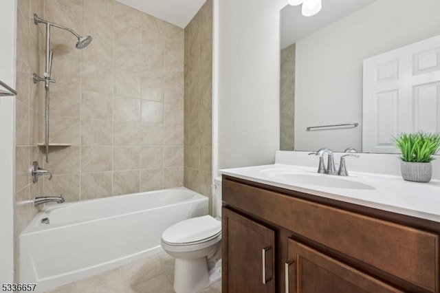 full bathroom featuring tile patterned floors, vanity, toilet, and tiled shower / bath combo