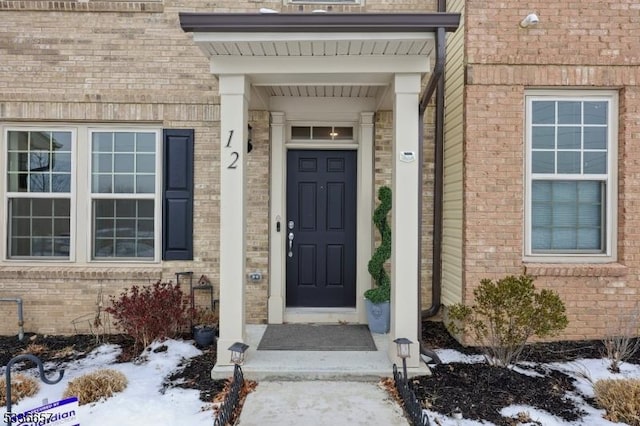 view of snow covered property entrance