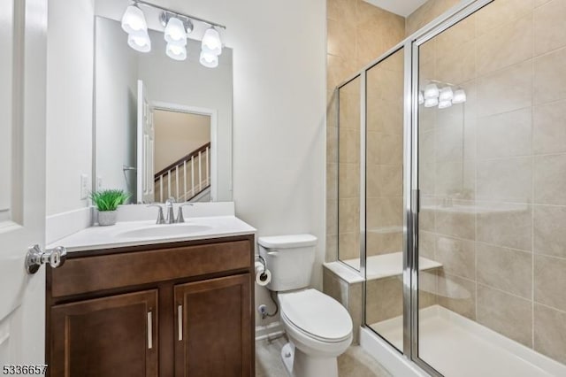 bathroom with vanity, toilet, and an enclosed shower