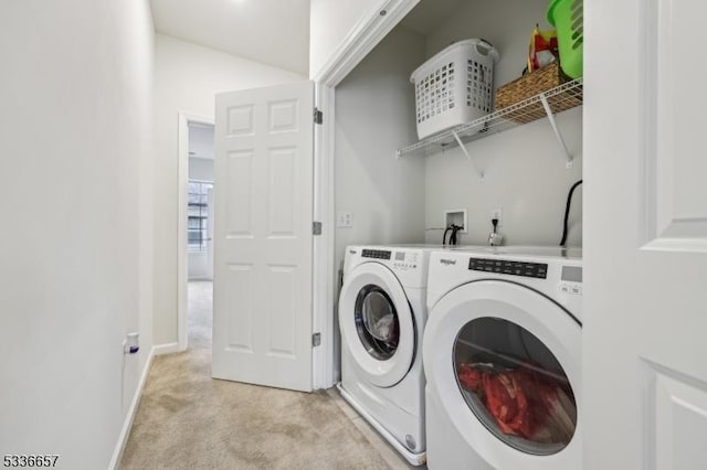 laundry room featuring separate washer and dryer and light carpet