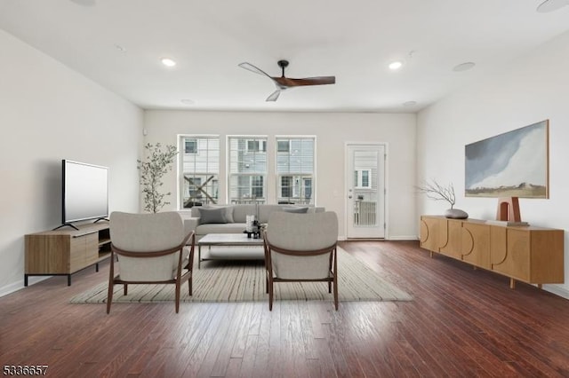 living room featuring dark hardwood / wood-style floors and ceiling fan