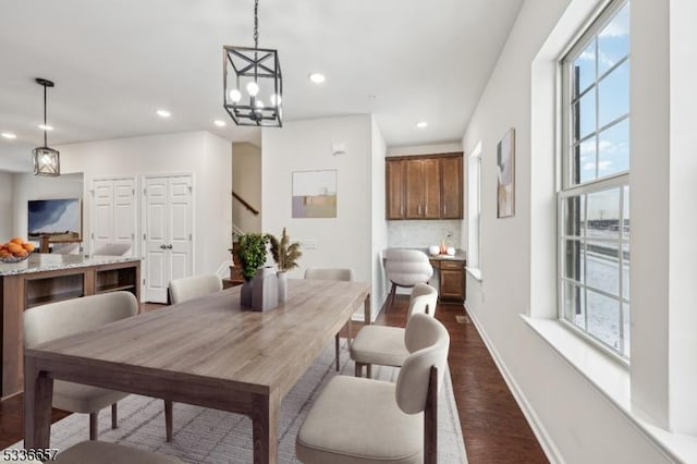 dining room featuring dark hardwood / wood-style flooring and a wealth of natural light