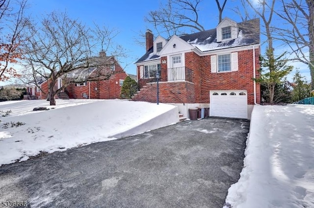 view of snow covered exterior with a garage