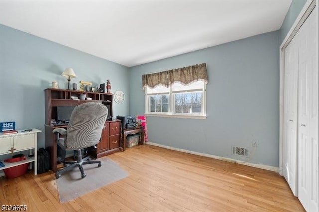 office with light hardwood / wood-style flooring