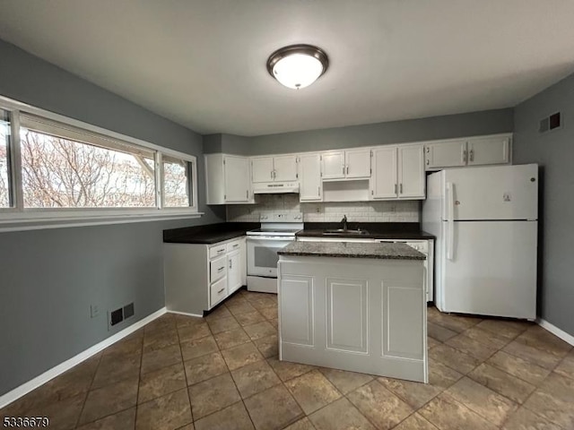 kitchen featuring sink, white appliances, white cabinetry, a center island, and tasteful backsplash