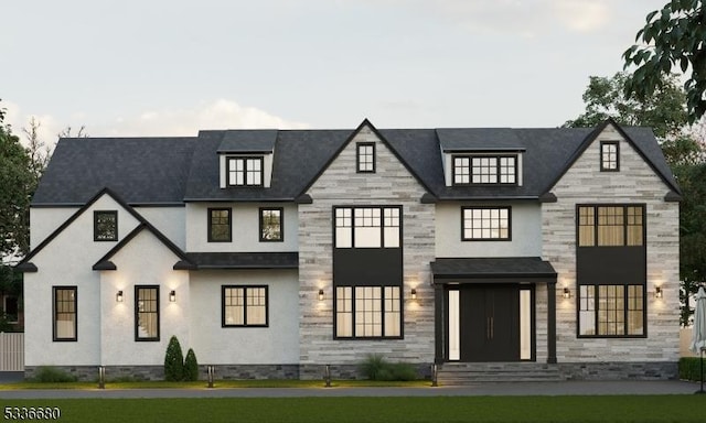 view of front of home featuring entry steps, stone siding, and a front yard