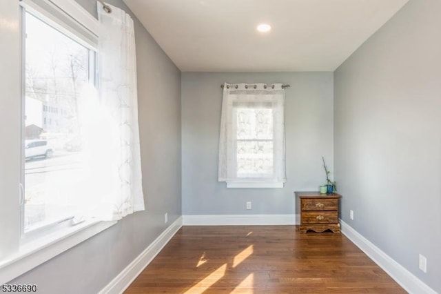 empty room with dark wood-type flooring