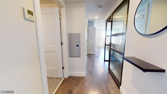 hall featuring electric panel and hardwood / wood-style floors