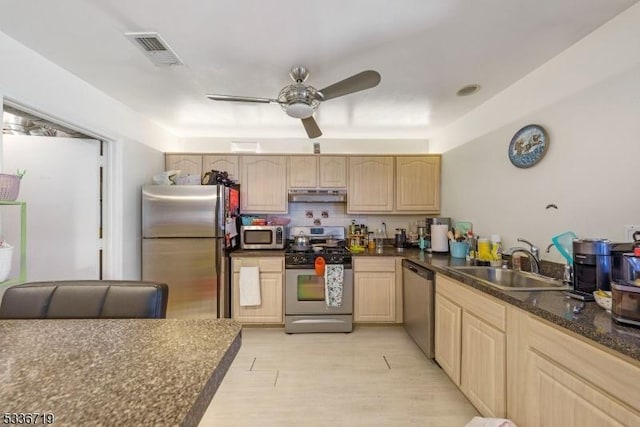 kitchen featuring stainless steel appliances, light brown cabinetry, visible vents, and under cabinet range hood