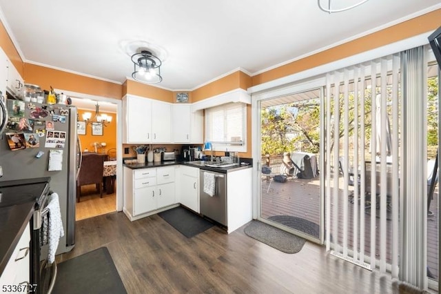 kitchen featuring stainless steel appliances, white cabinetry, ornamental molding, and a chandelier