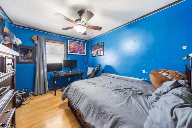 bedroom with ceiling fan and light hardwood / wood-style floors