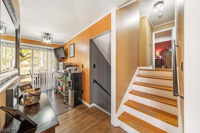 interior space with hardwood / wood-style flooring and ornamental molding