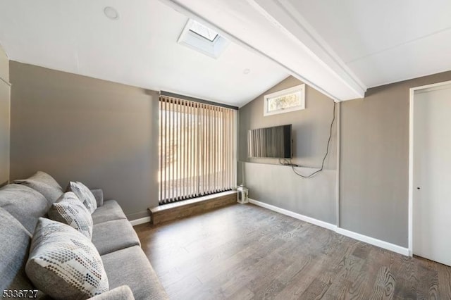 unfurnished living room with vaulted ceiling with skylight and hardwood / wood-style floors