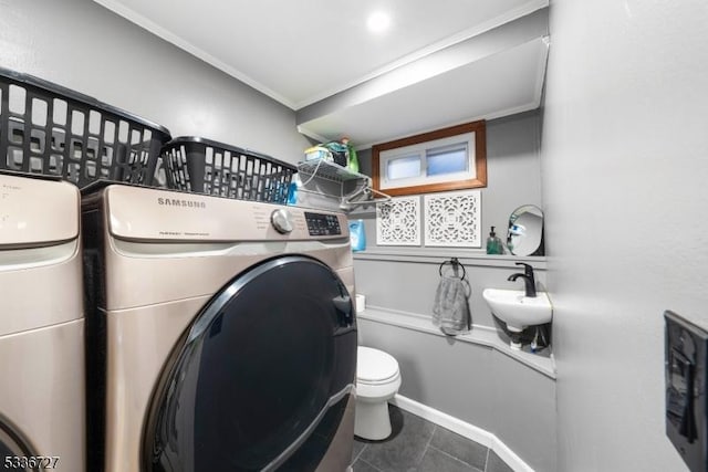 laundry room featuring tile patterned floors, sink, and washing machine and dryer