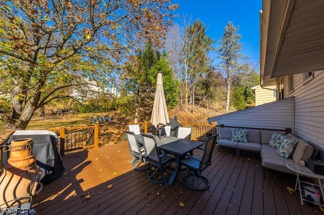 wooden terrace with an outdoor living space