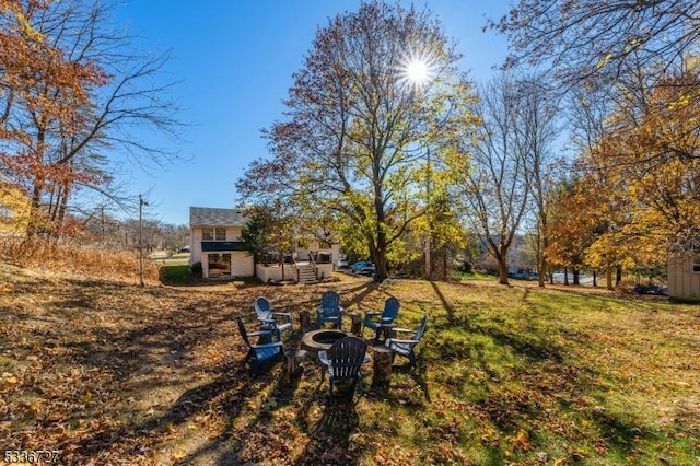 view of yard with a fire pit