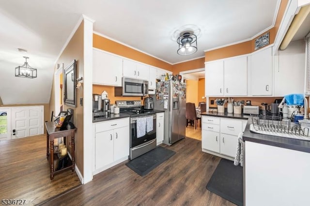 kitchen with white cabinetry, crown molding, dark wood-type flooring, and stainless steel appliances