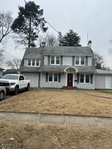 front facade featuring a garage and a front lawn