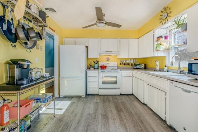 kitchen featuring sink, white cabinets, white appliances, and light hardwood / wood-style floors