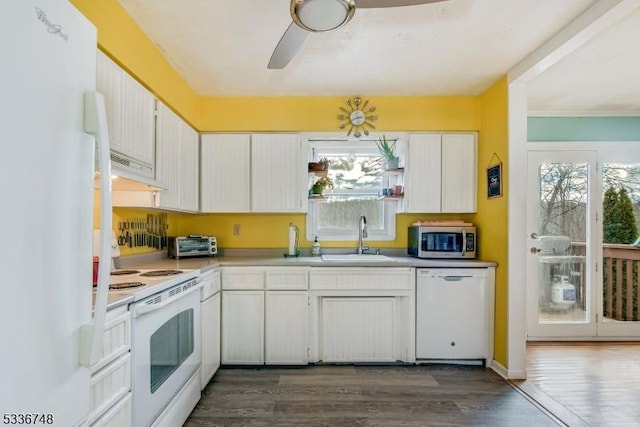 kitchen featuring dark wood-type flooring, white appliances, sink, and white cabinets