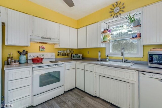 kitchen featuring white cabinetry, sink, hardwood / wood-style floors, and white appliances