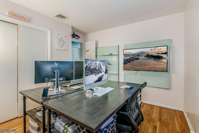 office area with light hardwood / wood-style floors