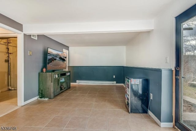 interior space featuring beamed ceiling, a baseboard radiator, and tile patterned flooring