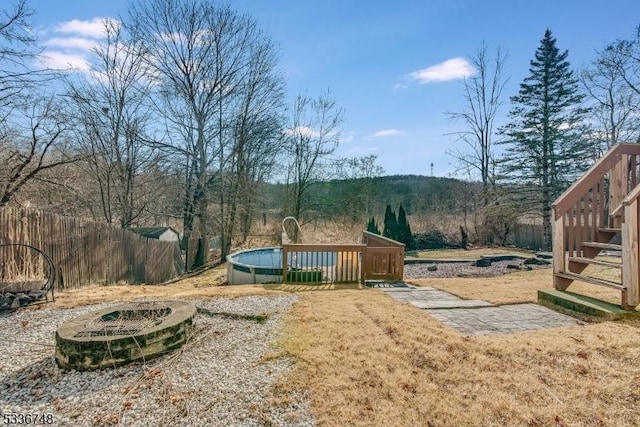 view of yard with a fenced in pool and a fire pit