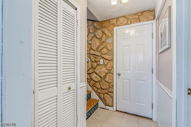 entryway with light tile patterned flooring