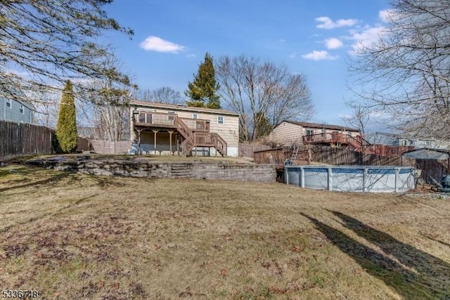 view of yard with a swimming pool side deck