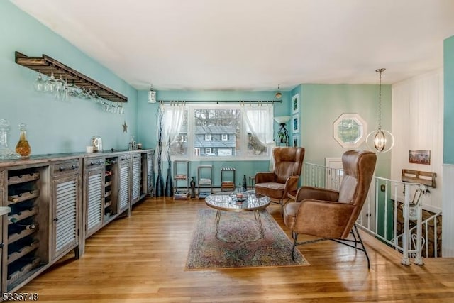 sitting room with hardwood / wood-style floors and a notable chandelier