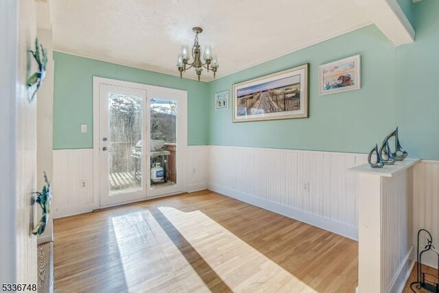 interior space featuring a notable chandelier and light wood-type flooring