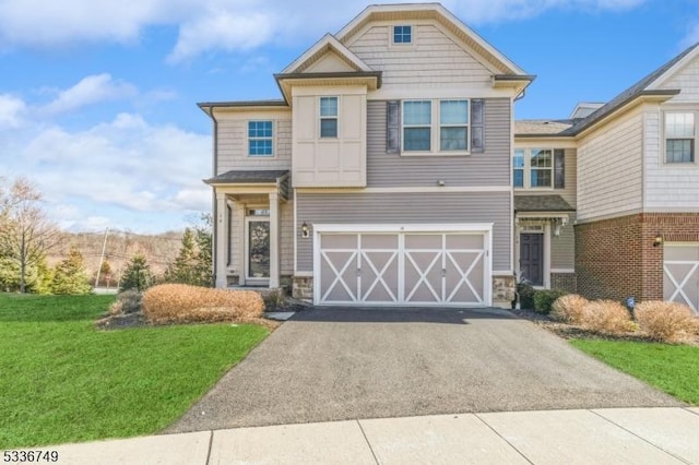 view of front of property with a garage and a front lawn