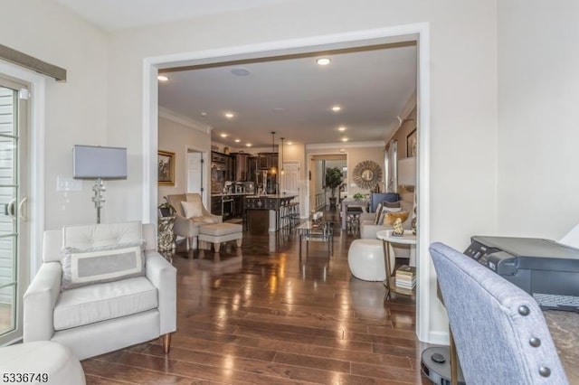 living room with ornamental molding and dark hardwood / wood-style flooring